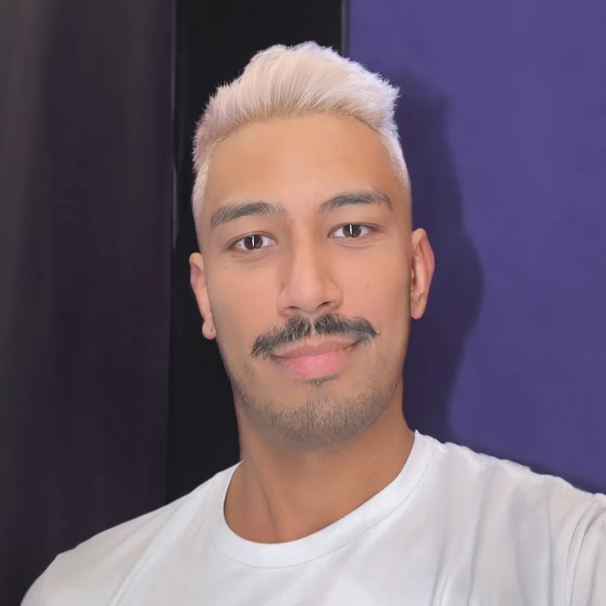 Shaun with bleached hair in a white t-shirt